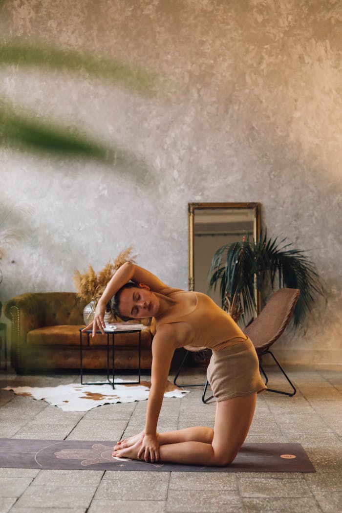 Mastering the First Impression: Your intriguing post title goes here A young woman practices yoga indoors in a peaceful, stylish setting.